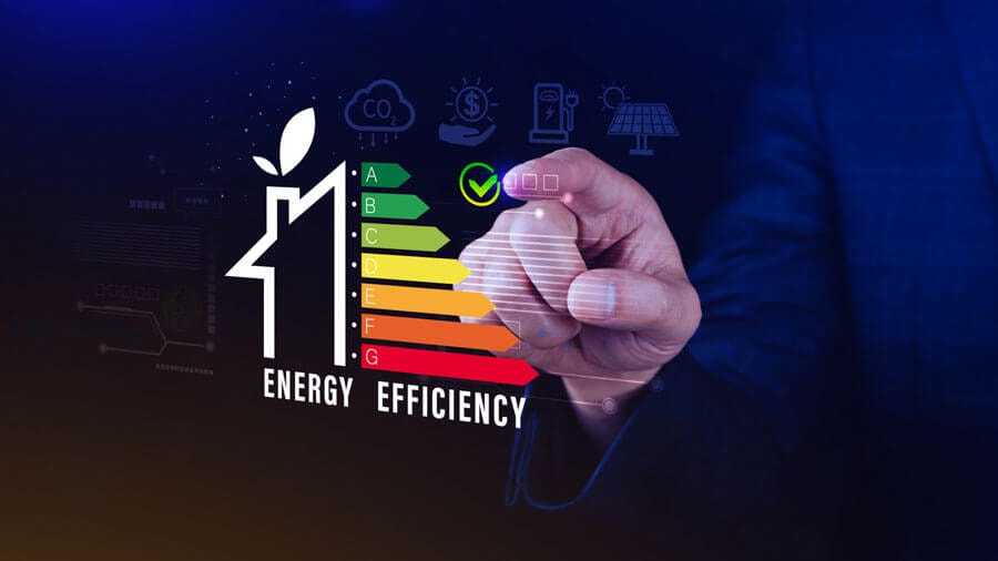 Schematic illustration of a home energy efficiency pyramid, with a hand pointing at it with an index finger against a dark background.