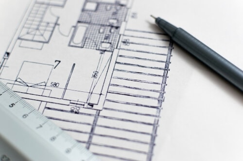 Close-up of a floor plan with a pen and ruler.