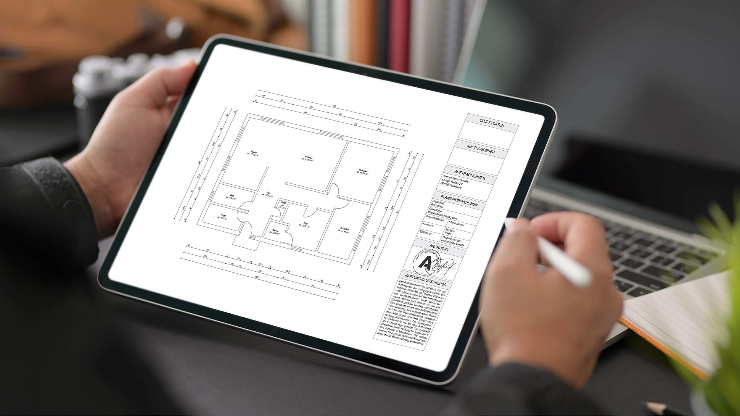 Close-up of a tablet held up showing the dimensioned floor plan of a 2.5-room apartment with an open kitchen, two bathrooms, a utility room, and an architect's stamp