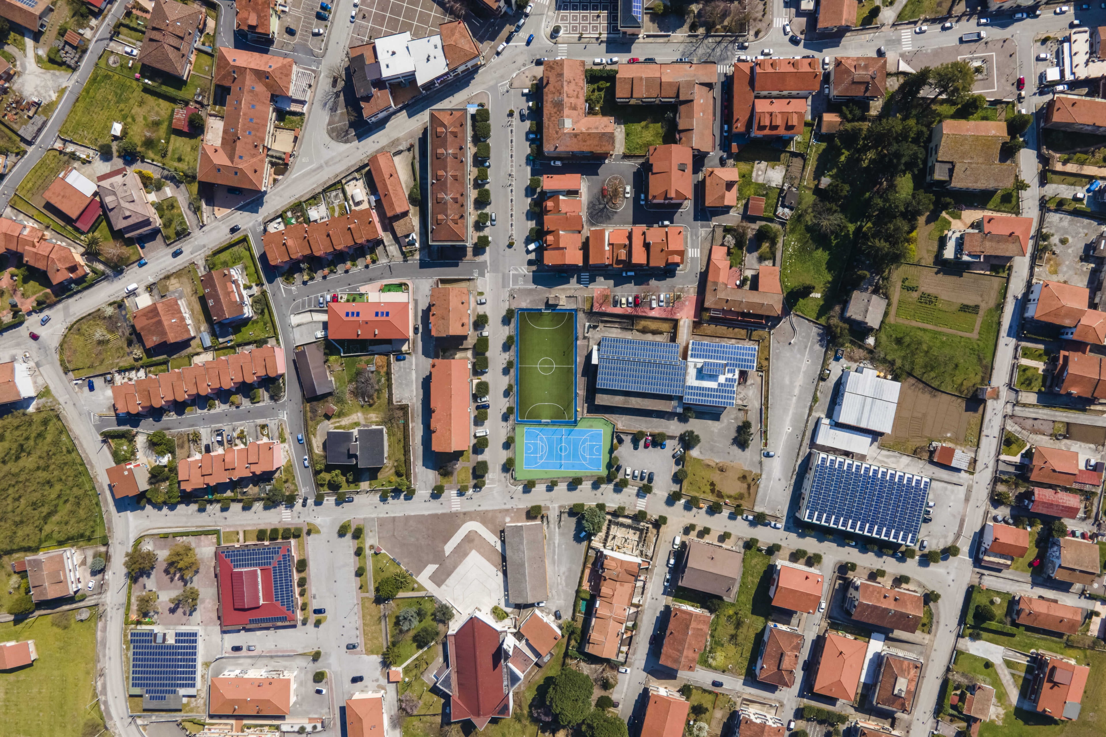 Aerial photo of an urban outskirts area including sports facilities and school buildings