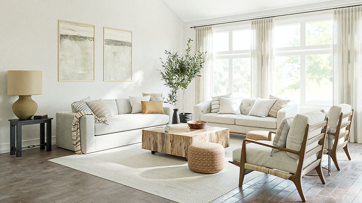 Corner view of a seating arrangement with various upholstered pieces around a square natural wood table on a rug, flooded with light through windows at the back.
