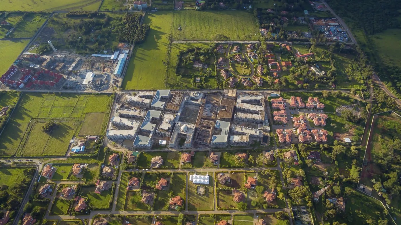 Aerial photo of a mixed urban outskirts area with residential development and industrial facilities