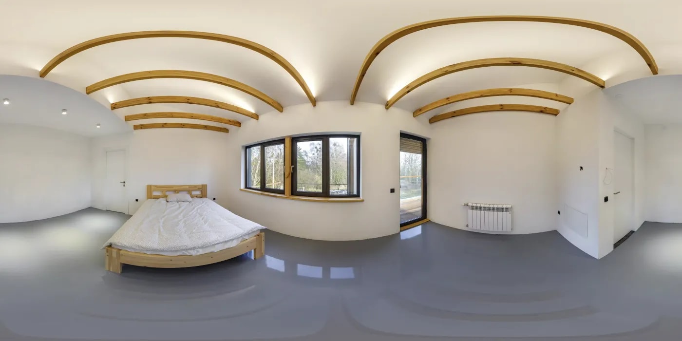 360-degree shot of a bright room with ceiling beams and a wooden bed, through whose window a balcony and trees can be seen