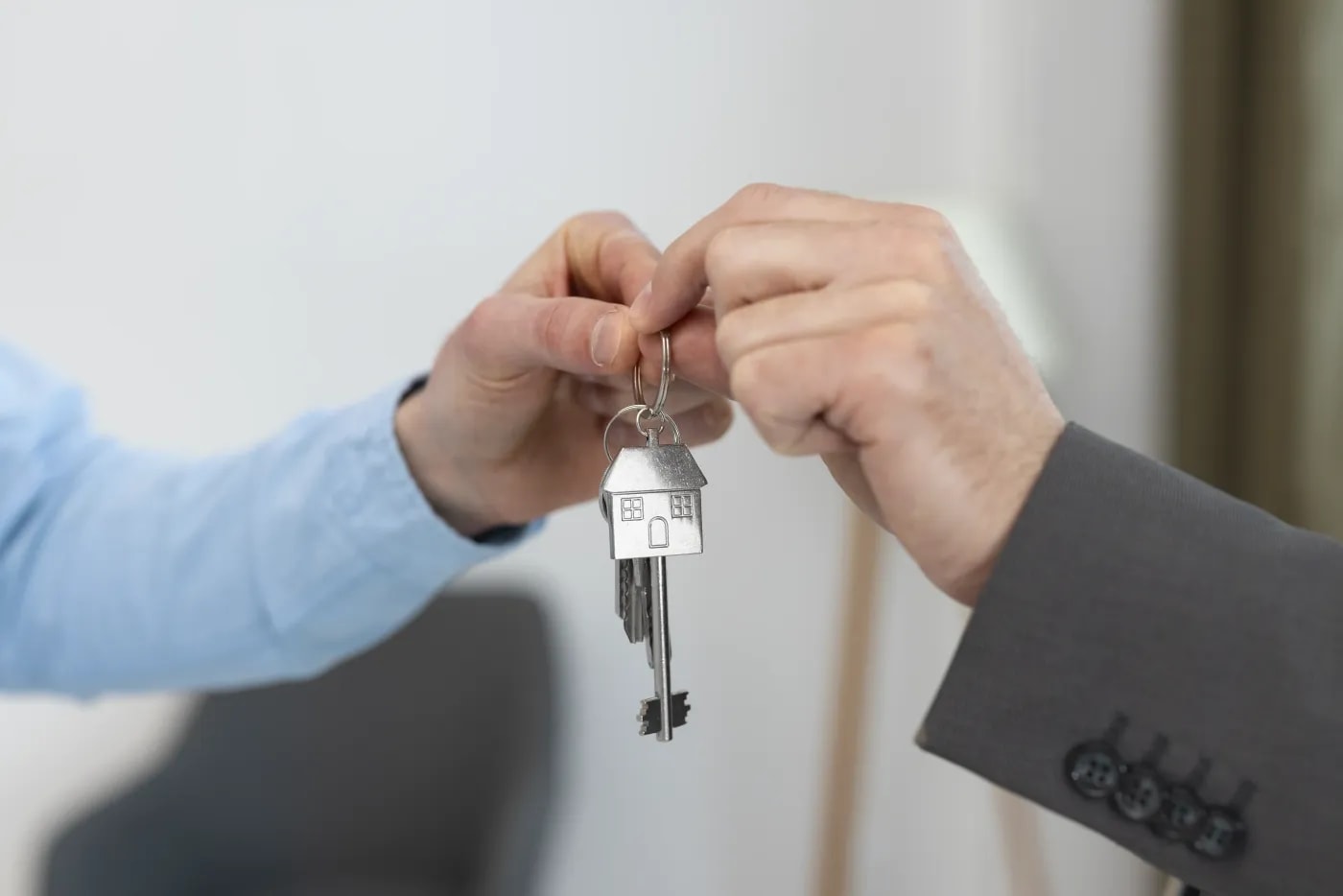 Close-up of two hands during a key handover.